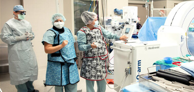 Dr. Jonathon Geisinger and nurses stand ready in an operating room